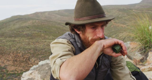 Thoughtful Outdoorsman Resting on Mountain Top - Download Free Stock Images Pikwizard.com