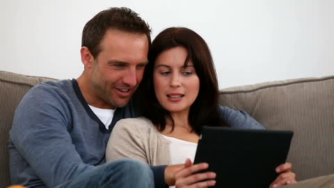 Couple Engaging in Conversation on Comfortable Sofa
