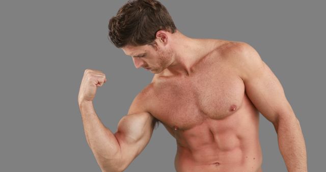 Muscular Man Flexing Bicep in Studio - Download Free Stock Images Pikwizard.com