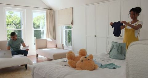 Couple Managing Family Tasks at Home, Bonding Through Teamwork