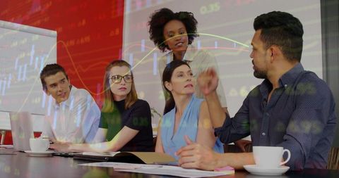 Diverse Professionals Analyzing Financial Data in Modern Meeting