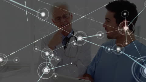 Two Doctors Discussing Networked Technology in Healthcare