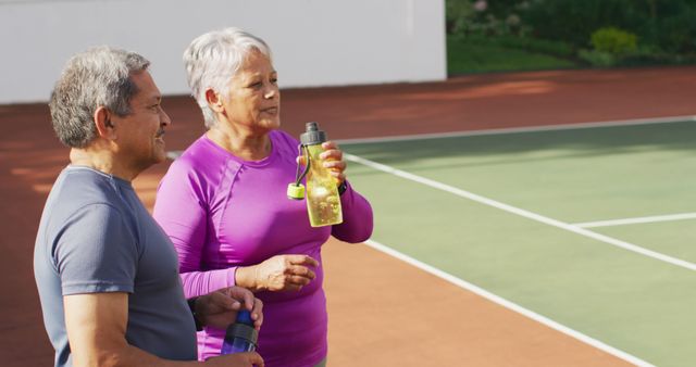 Senior Couple Taking a Break After Tennis Match Outdoors - Download Free Stock Images Pikwizard.com