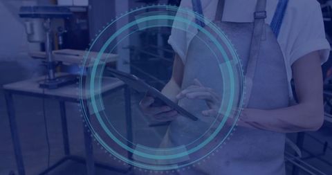 Craftsman Using Tablet for Precision in Workshop Environment