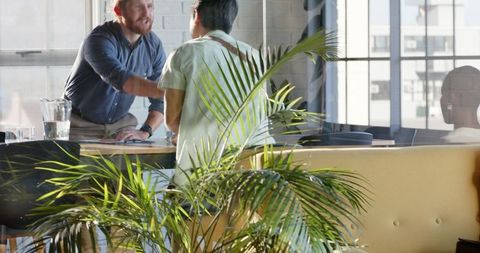 Colleagues Collaborating Confidently in Modern Office Room