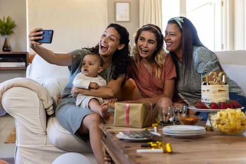 Diverse Friends Celebrating with Baby Taking Selfie Together