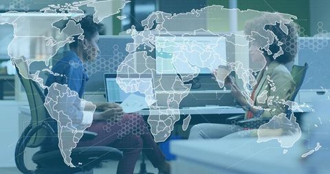 Colleagues Collaborating in Open Office with World Map Overlay Showing Global Connectivity