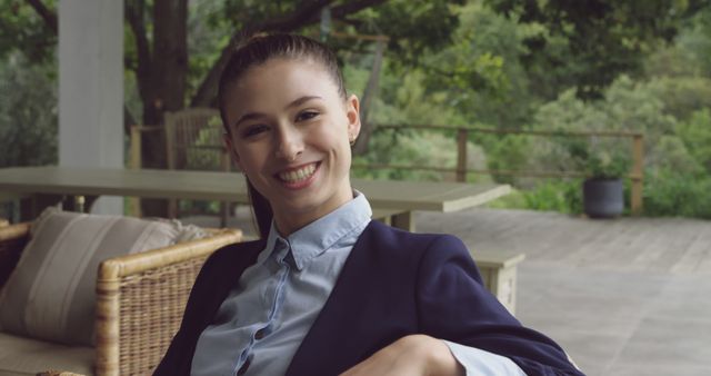 Businesswoman smiling outdoors at a patio workspace - Download Free Stock Images Pikwizard.com