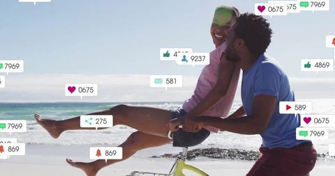 Couple Cycling on Beach with Social Media Engagement Icons