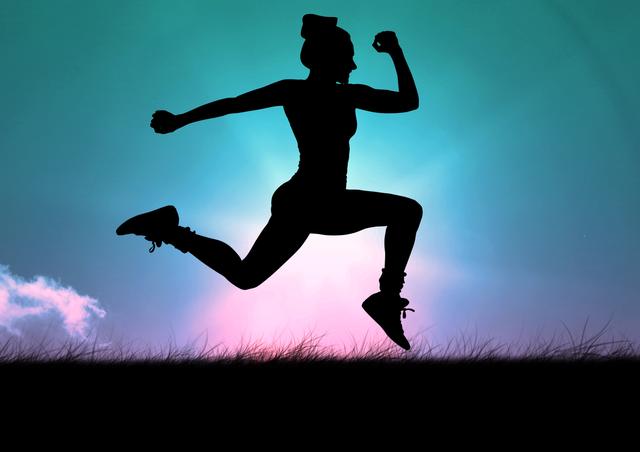Silhouette of a fit woman leaping in the air against a vibrant, colorful sky. Ideal for use in fitness and health promotions, motivational posters, athletic apparel advertisements, and outdoor activity campaigns.