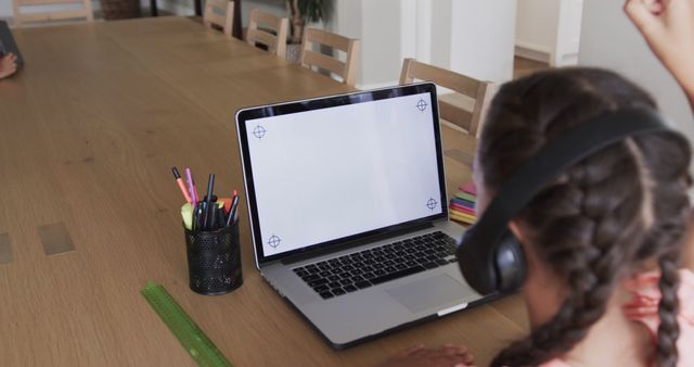 Excited Child Attending Online Class with Headphones on Laptop - Download Free Stock Images Pikwizard.com