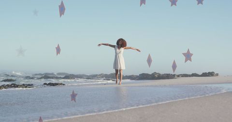 Joyful African American Woman with Artistic Stars at Beach