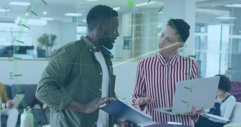 Professional team discussing documents and ideas in modern office