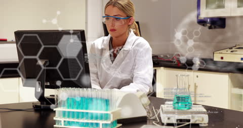 Lab Technician Analyzing Data With Overlay of Chemical Formulas