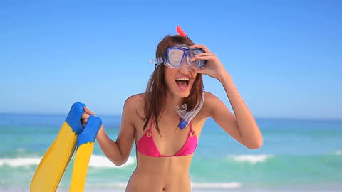 Joyful Woman with Snorkeling Gear on Sunny Beach Holiday