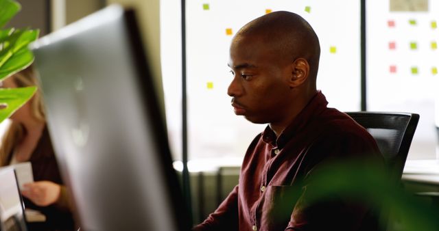 Focused African American Professional Working at Computer in Office - Download Free Stock Photos Pikwizard.com