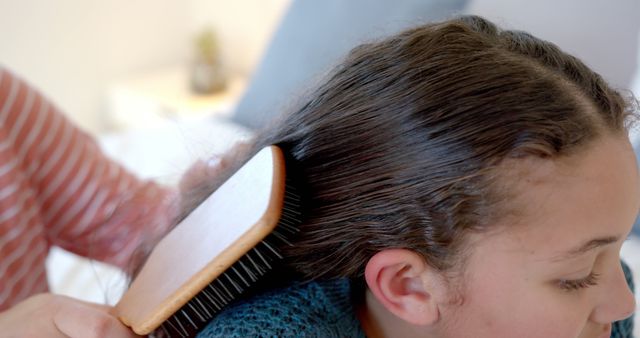 Parent brushing daughter's hair at home - Download Free Stock Images Pikwizard.com