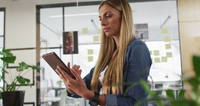 Focused Young Professional Woman Using Tablet in Modern Office - Download Free Stock Images Pikwizard.com