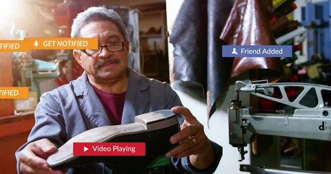 Senior cobbler inspecting shoe sole in workshop