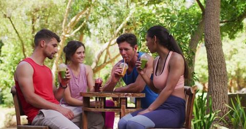 Friends Enjoying Healthy Smoothies Post Yoga in Sunny Park