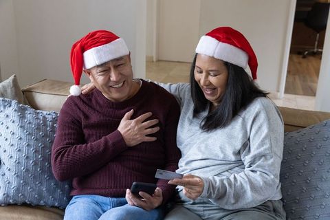 Senior Couple Enjoying Online Holiday Shopping Together