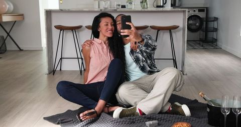 Couple Celebrating Engagement at Home with Selfie