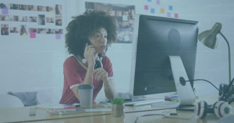 Focused Businesswoman Analyzing Data on Computer at Modern Desk
