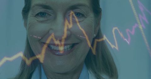 Smiling Senior Doctor Analyzing Medical Data with Graphs