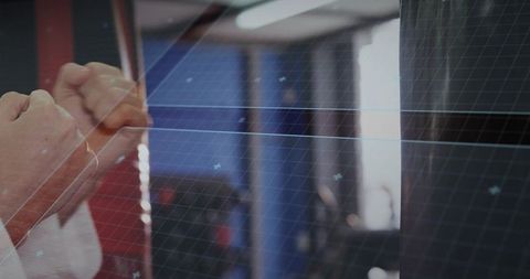 Martial artist training with heavy bag in gym featuring grid tutorial