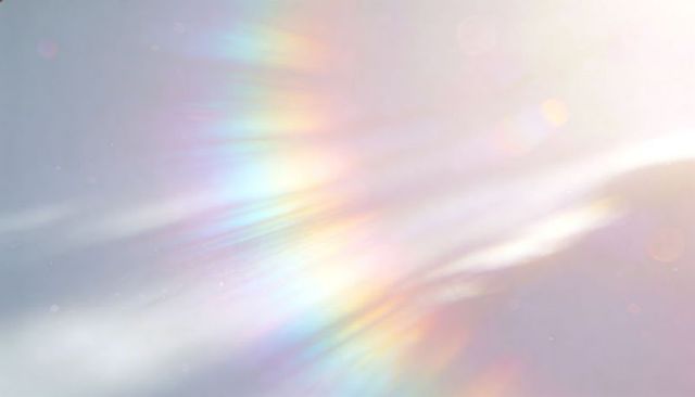 Prismatic sunlight scattering across pastel sky with diagonal rainbow streaks