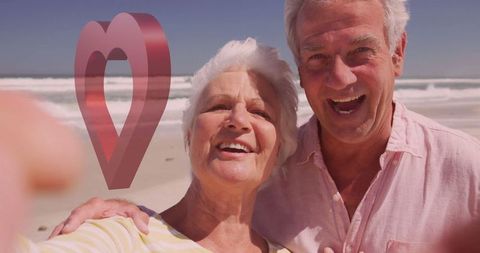 Joyful Senior Couple Taking Selfie on Sunny Beach