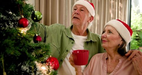 Senior Couple Decorating Christmas Tree Together, Festive Spirit