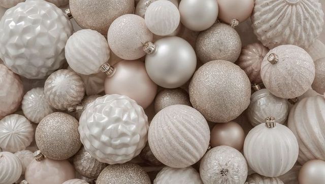Neutral champagne and pearl holiday ornaments filling frame with textured elegant baubles