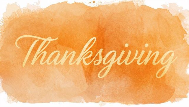 Thanksgiving cursive lettering on orange watercolor wash background for holiday greeting