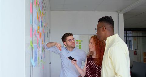 Creative Team Collaborating on Project with Sticky Notes