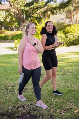 Two Women Enjoying Outdoor Exercise in a Park Setting