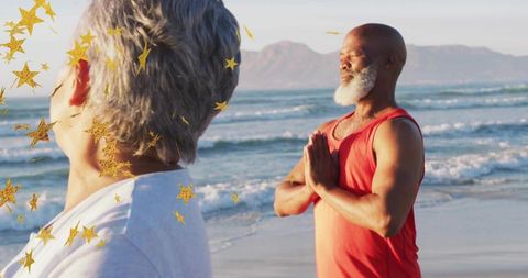 Praying man meditating on beach at sunrise with companion and gold star confetti overlay