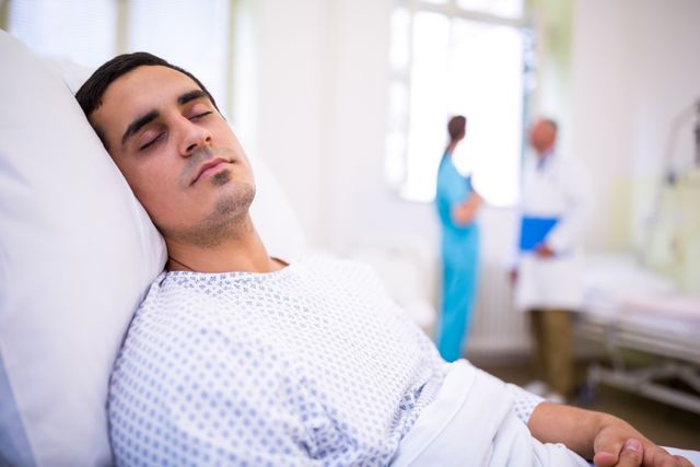 Close-up of patient sleeping on bed in hospital