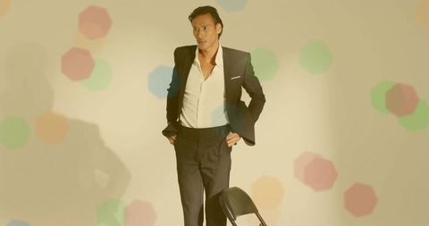 Stylish Businessman Posing in Welsh Showroom with Hexagon Projection Pattern