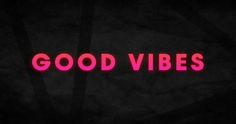 Good vibes pink neon glow on dark textured background minimalist neon typography poster