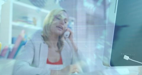 Businesswoman using telephone and computer with 5g data graphics overlay