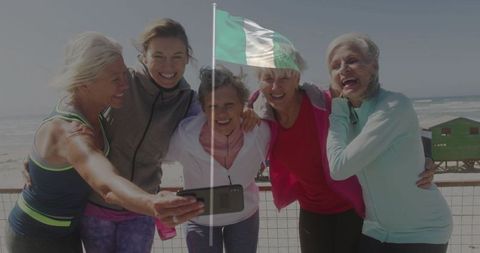 Senior Women Taking Selfie on Boardwalk Celebrating Friendship