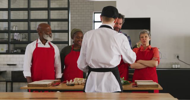 Diverse group of people attending cooking class led by chef instructor - Download Free Stock Images Pikwizard.com