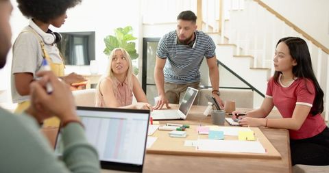 Diverse Team Collaborating in Modern Living Room Workspace