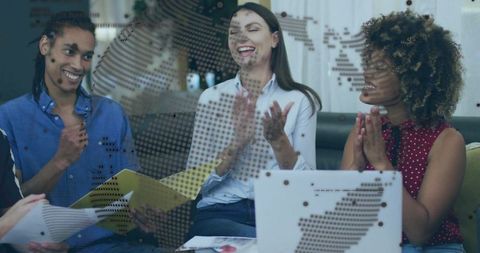 Colleagues Applauding Success in Collaborative Meeting Setting