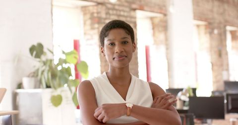 Confident Entrepreneur Smiling in Modern Office Environment