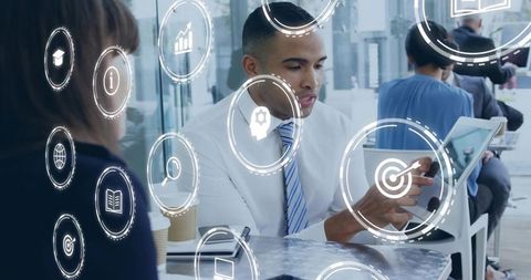 Pointing tablet and interacting with virtual business icons in modern coworking cafe