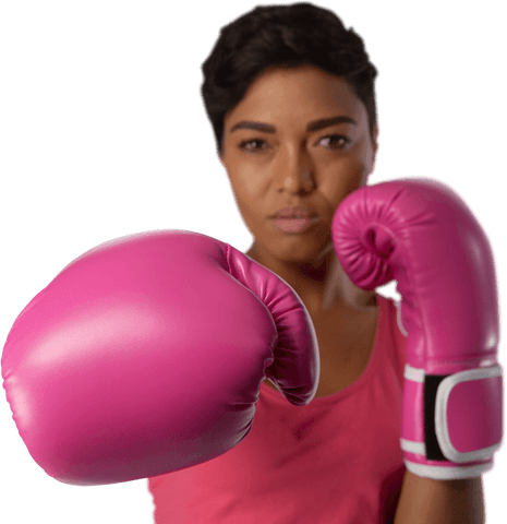 Determined female boxer punching for breast cancer awareness transparent