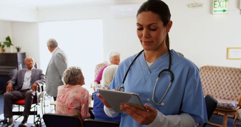 Caucasian Nurse Using Digital Tablet in Active Nursing Home Environment