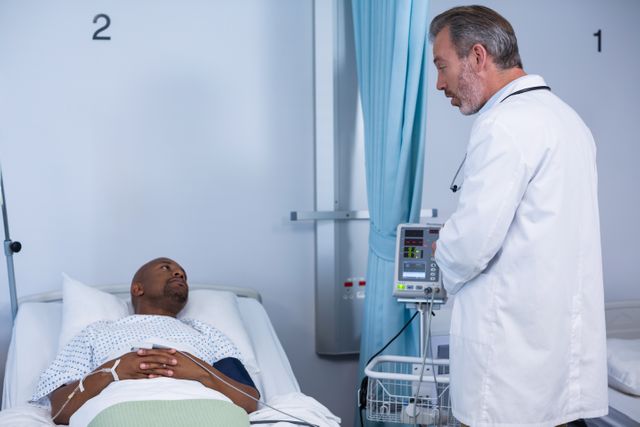 Doctor standing next to hospital bed, interacting with patient during visit. Suitable for healthcare, medical treatment, patient care, hospital environment, and doctor-patient relationship themes.